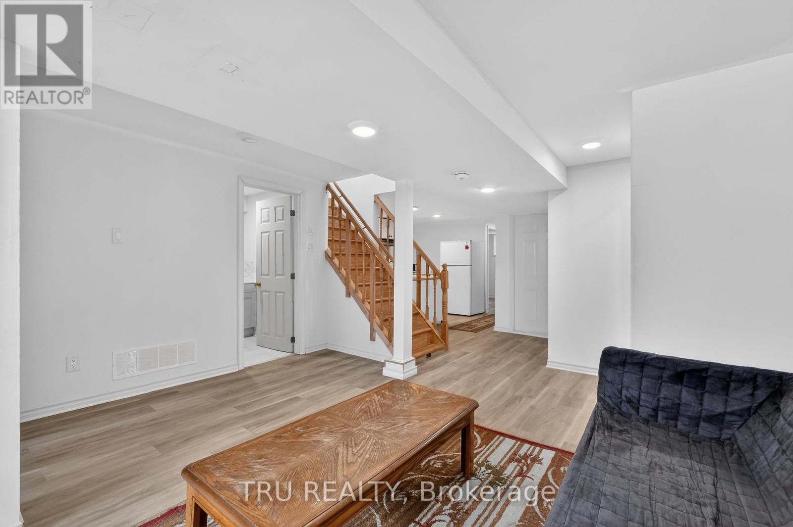 A spacious room with a staircase and a wooden coffee table.