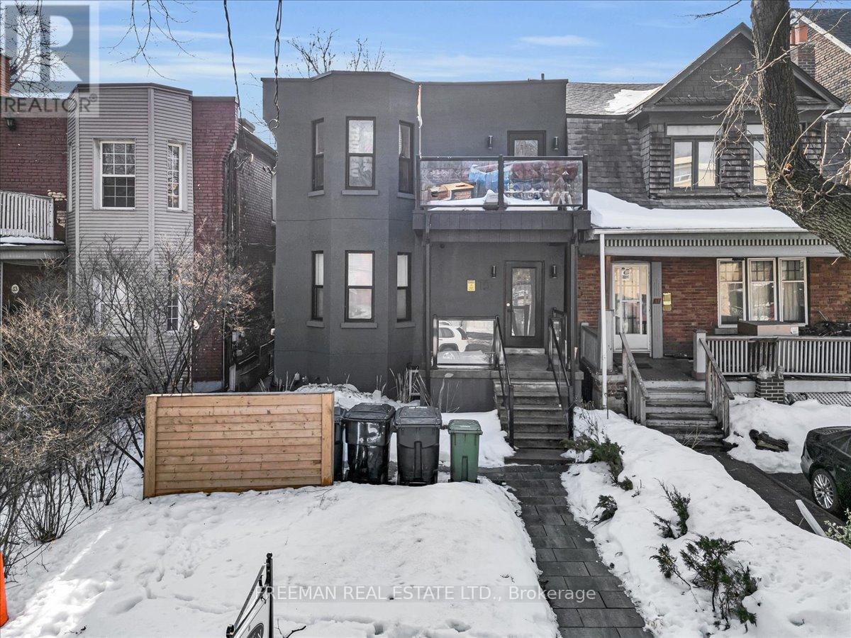 A snow-covered street with a house and a car parked in front.
