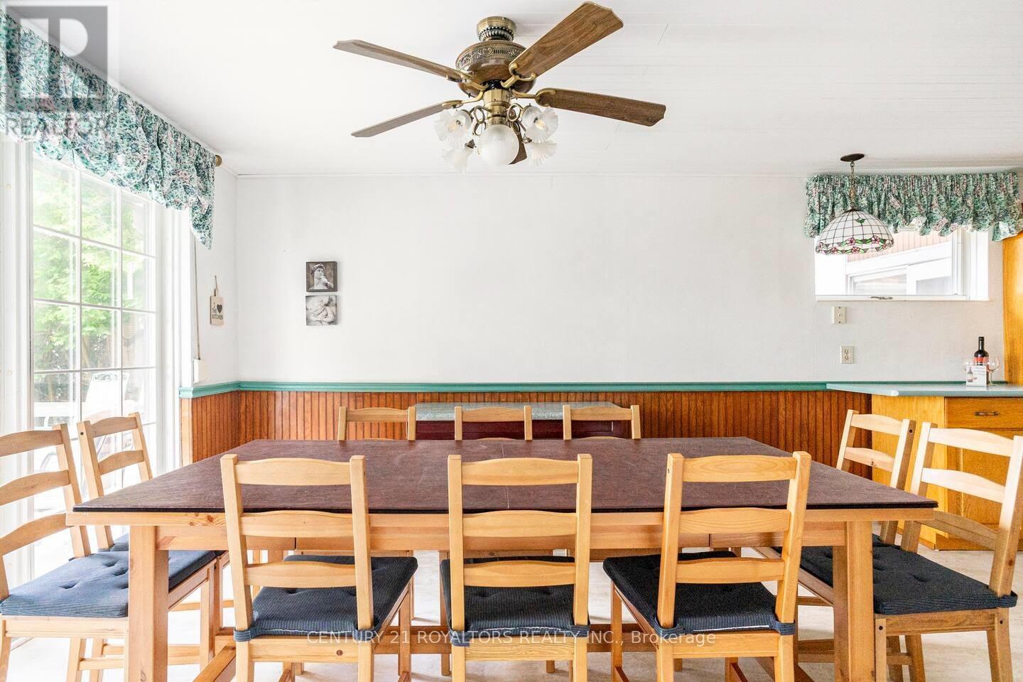 A dining room with a table and chairs.