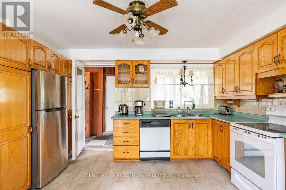 A kitchen with wooden cabinets and a refrigerator.