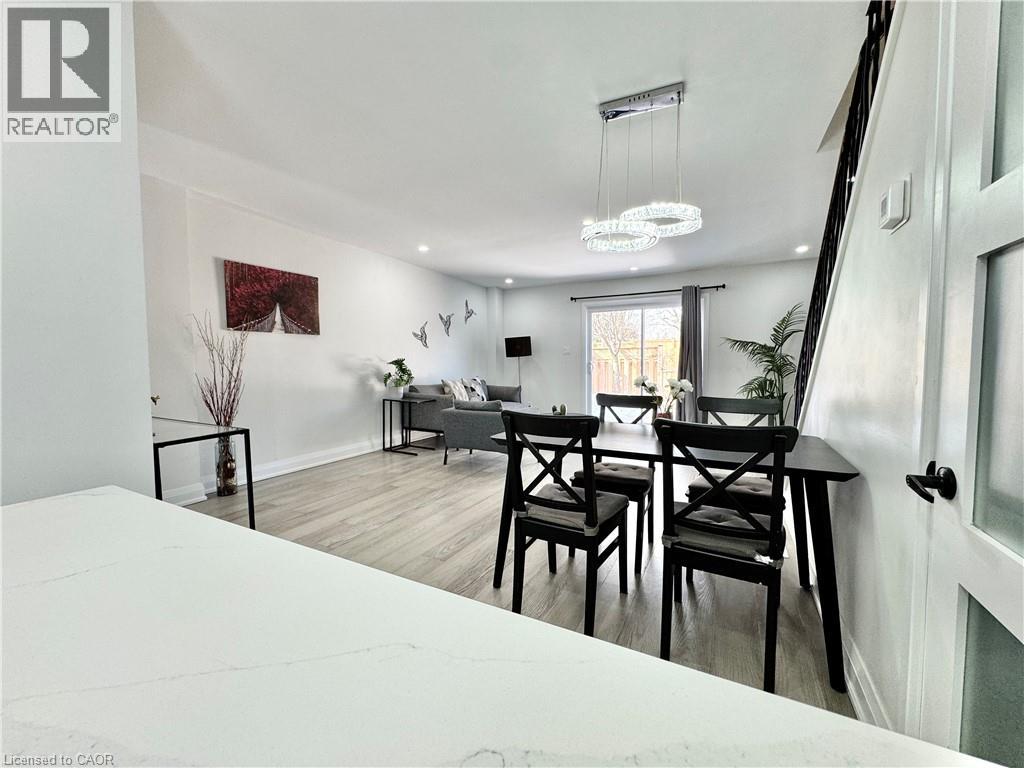 A dining room with a table and chairs.