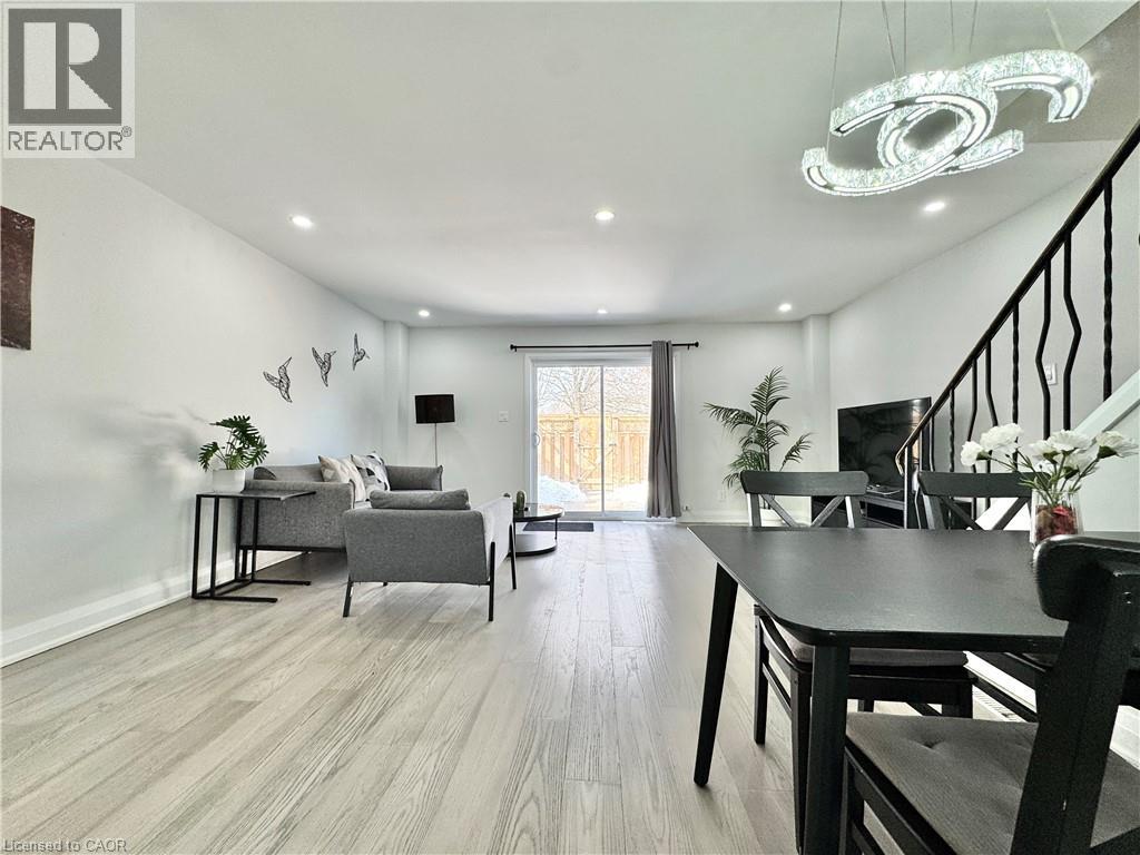 A well-lit living room with a dining table and chairs.