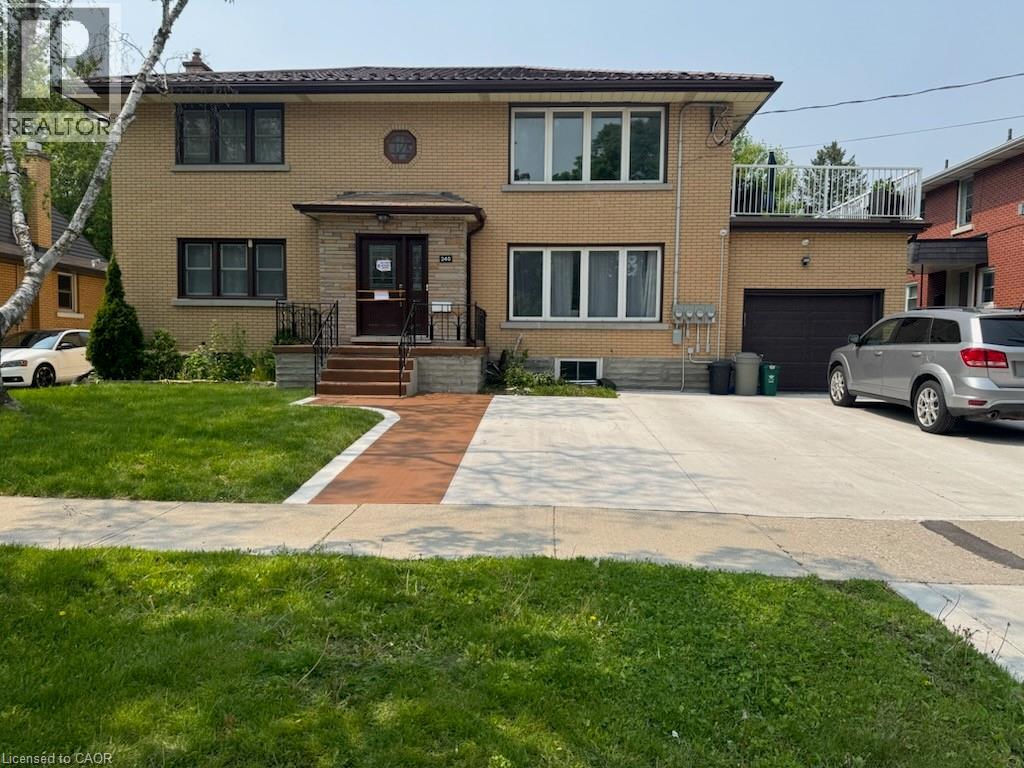 A house with a brown brick exterior and a white garage door.