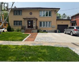 A house with a brown brick exterior and a white garage door.