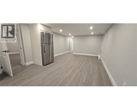 A spacious room with a Realtor sign on the door.