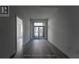 A spacious room with a door leading to a balcony.