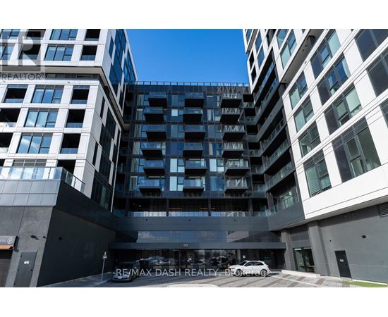 A modern building with the sign RE/MAX DASH REALTY-BROKERED in front of it.