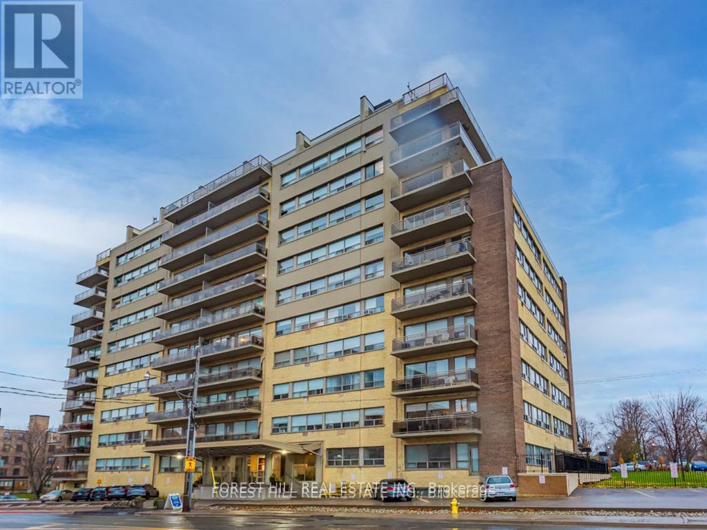 A tall apartment building with the words "FOREST HILL REAL ESTATE" on the front.