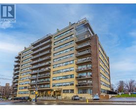 A tall apartment building with the words "FOREST HILL REAL ESTATE" on the front.