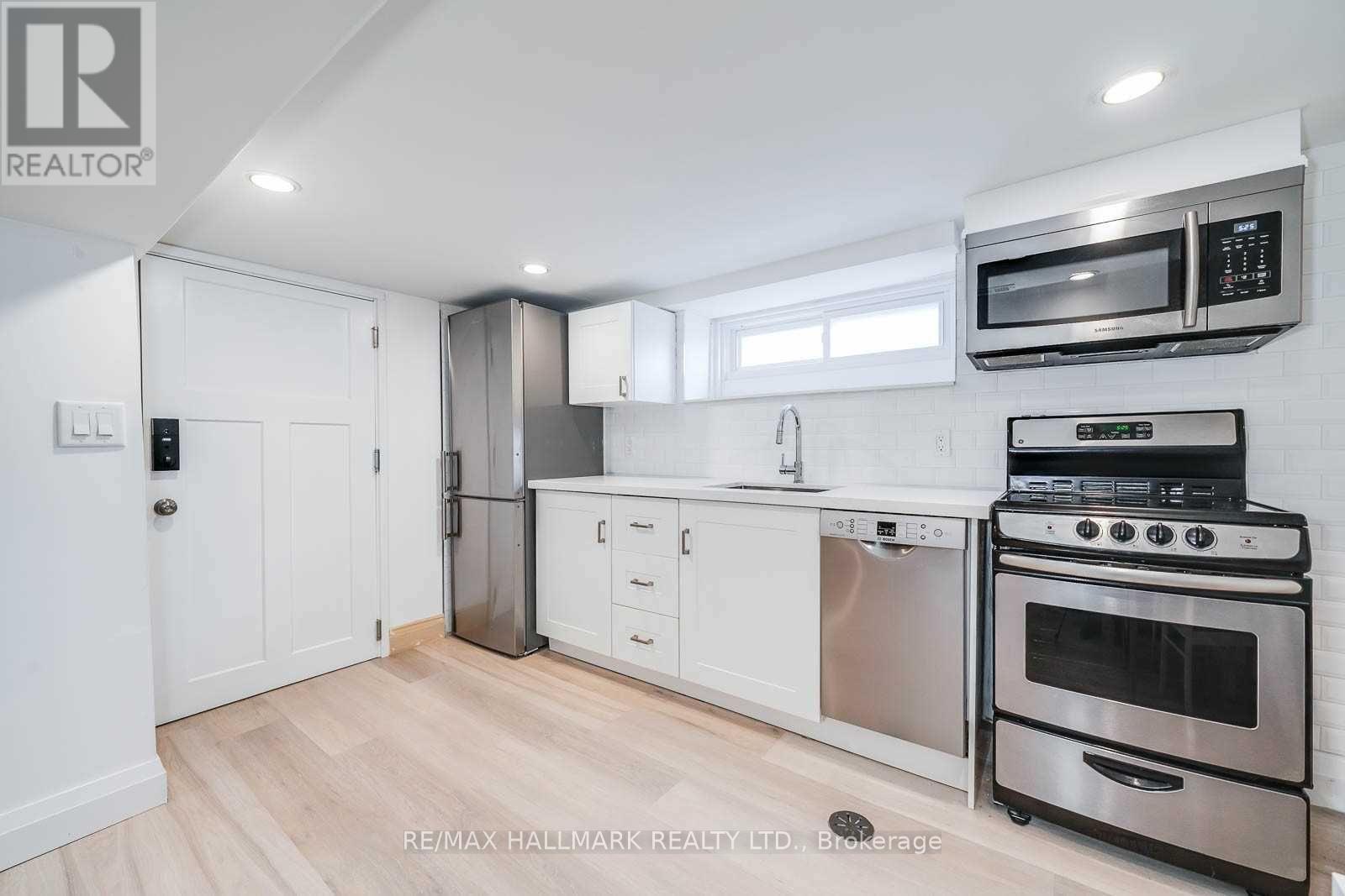 A kitchen with white cabinets and stainless steel appliances.