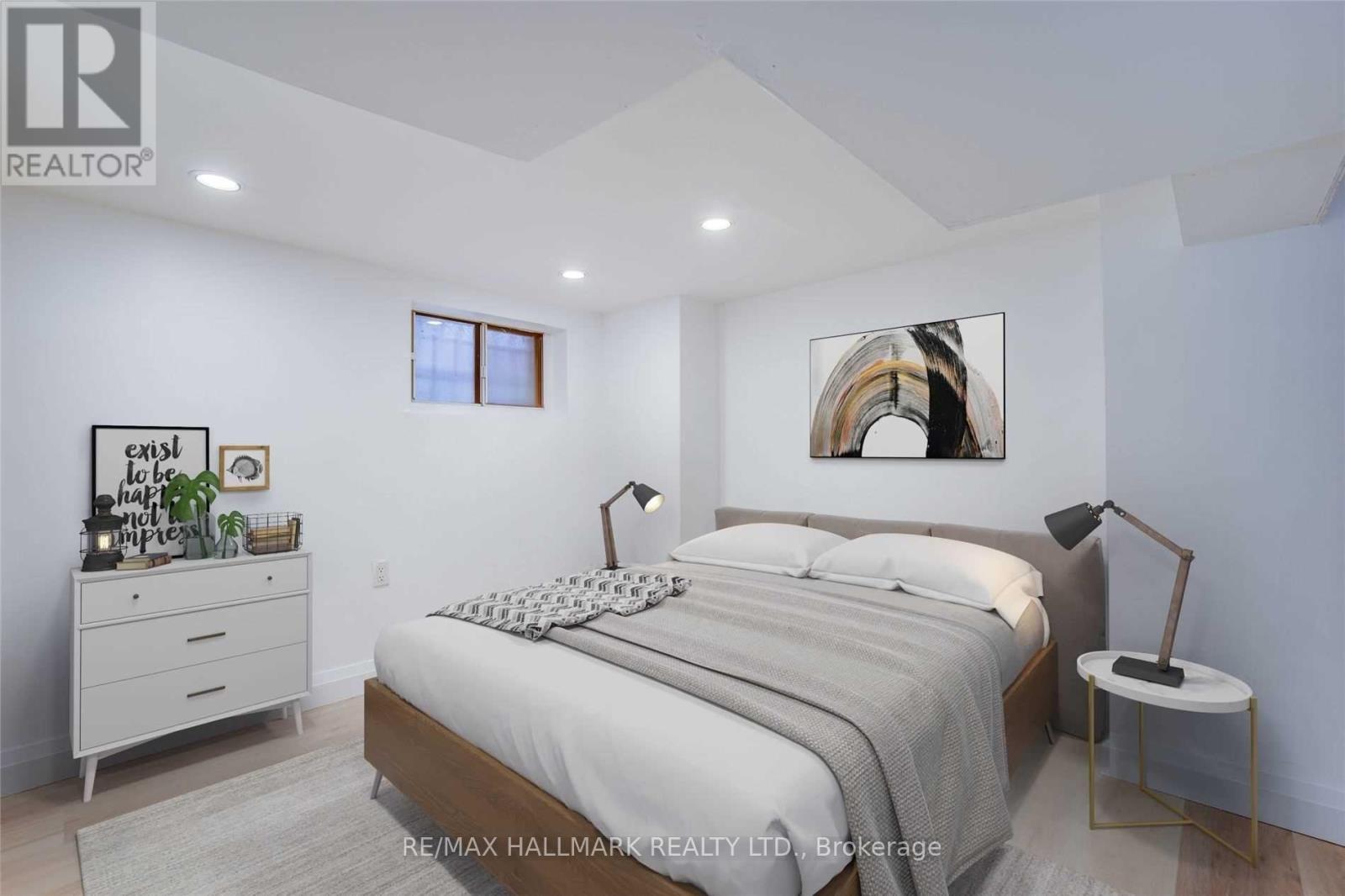 A bedroom with a bed, nightstand, and lamp.