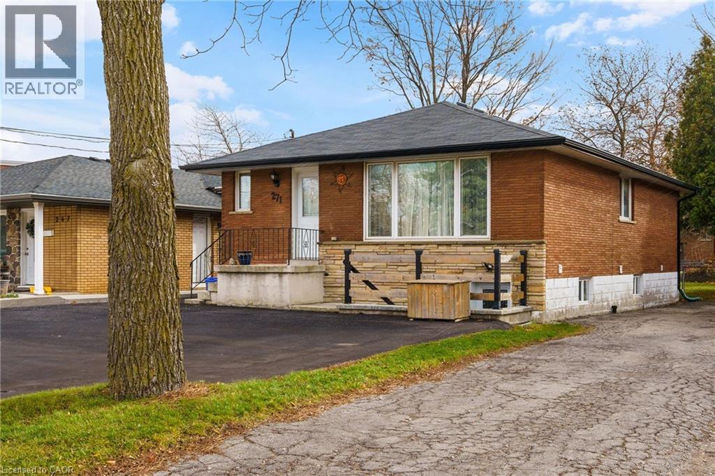 A house with a brick exterior and a black roof is for sale.