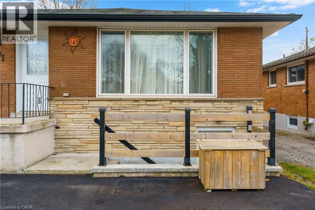 A house with a brick wall and a wooden box in front.