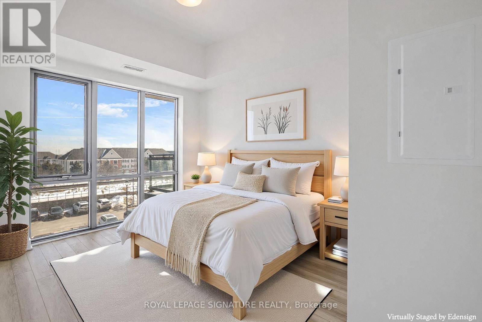 A bedroom with a large bed and a view of the outside.