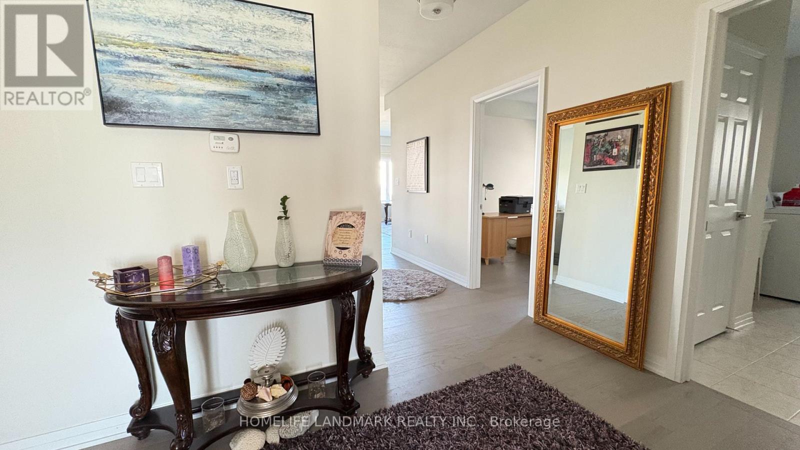 A living room with a table and a painting on the wall.