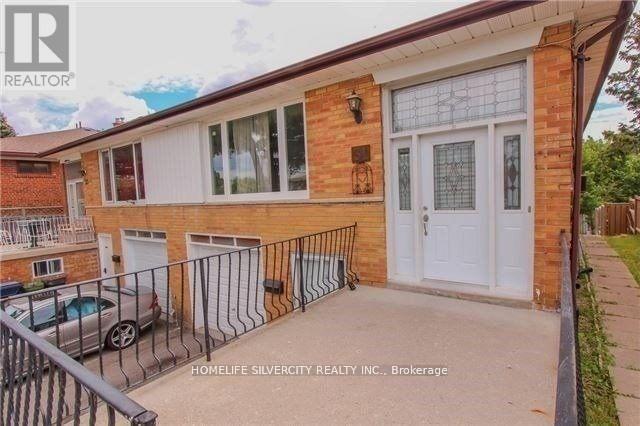 A brick house with a white door and windows is for sale.