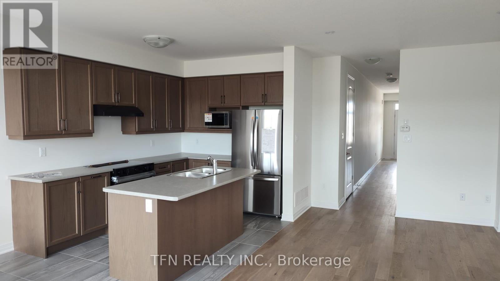 A kitchen with brown cabinets and a white countertop.