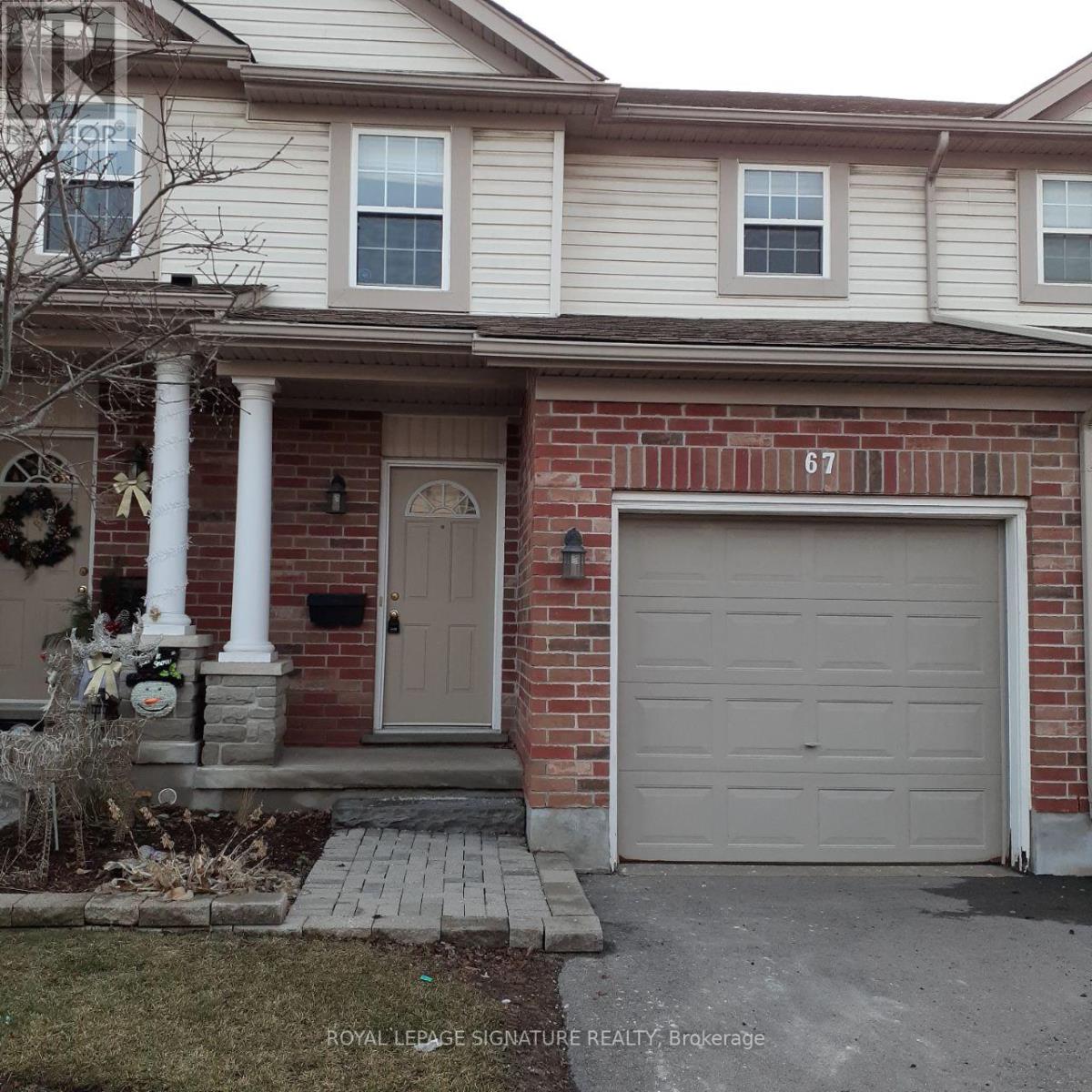A house with the number 67 on the garage door.