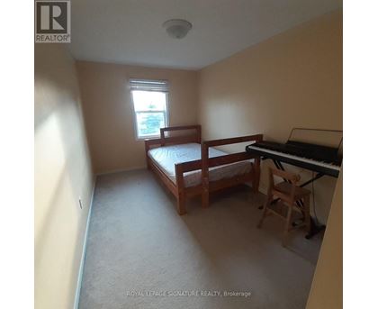 A bedroom with a bed, chair, and piano.