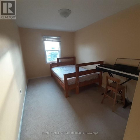 A bedroom with a bed, chair, and piano.