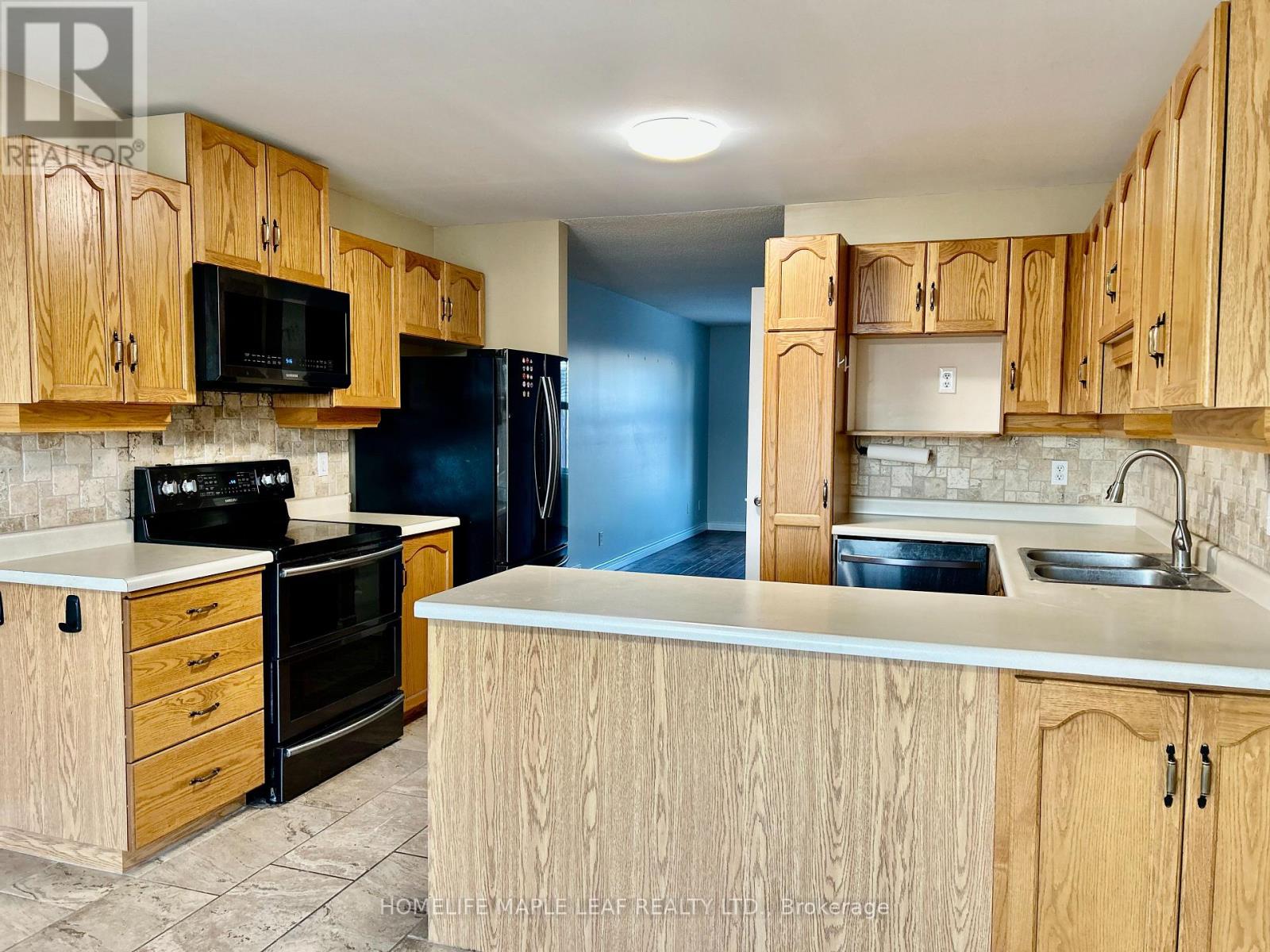 A kitchen with wooden cabinets and appliances.