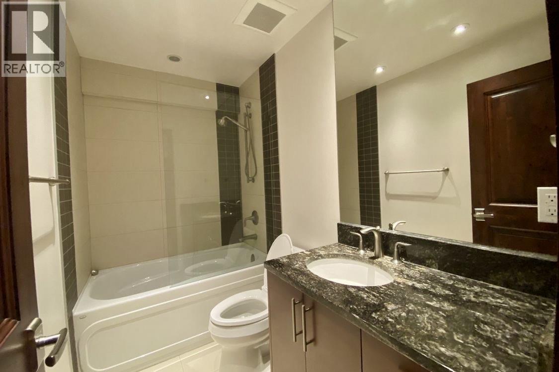 A bathroom with a sink, toilet, and bathtub.