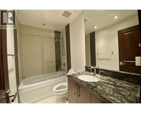 A bathroom with a sink, toilet, and bathtub.