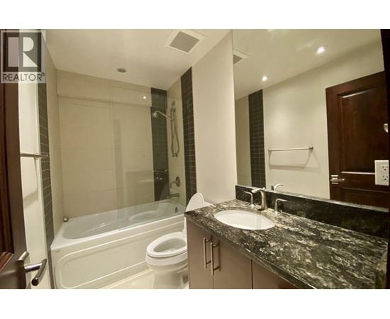A bathroom with a sink, toilet, and bathtub.