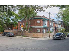 A brick house with a green trim and a sign that says 30.