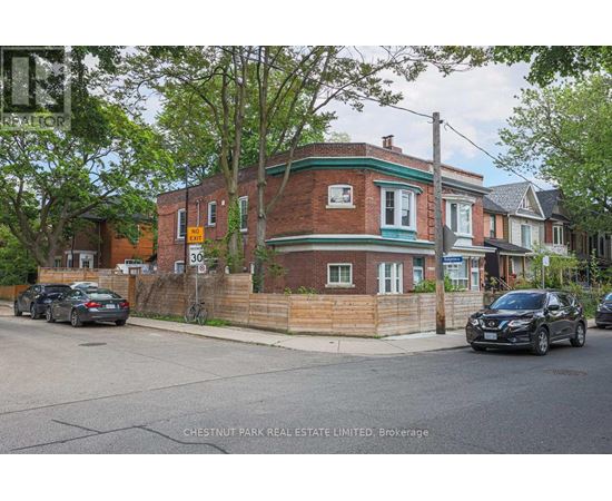 A brick house with a green trim and a sign that says 30.