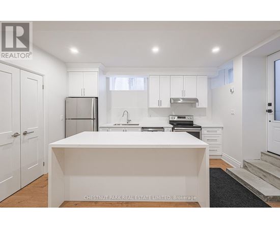 A white kitchen with a large island in the middle.