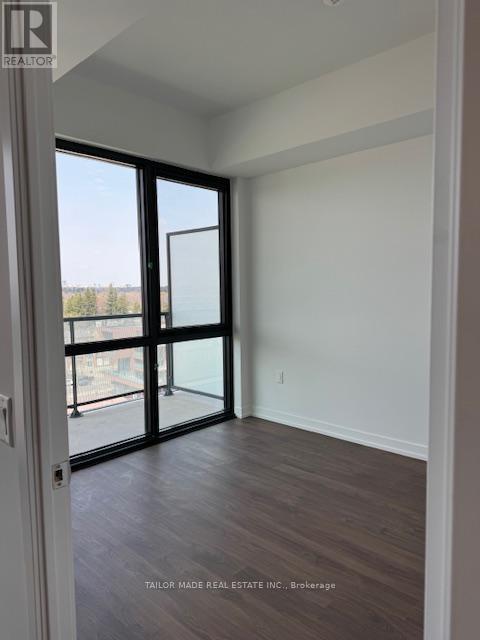 A room with a sliding glass door leading to a balcony.
