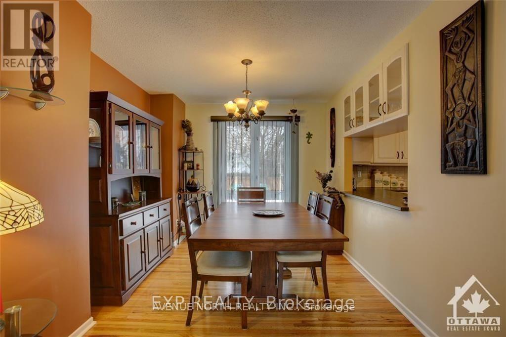 A dining room with a wooden table and chairs.
