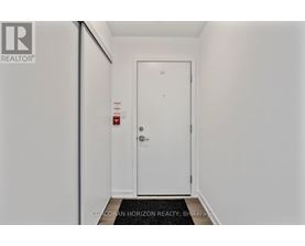 A white door with a fire extinguisher on the wall.