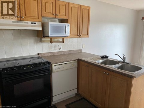 A kitchen with a black oven, a microwave, and a dishwasher.