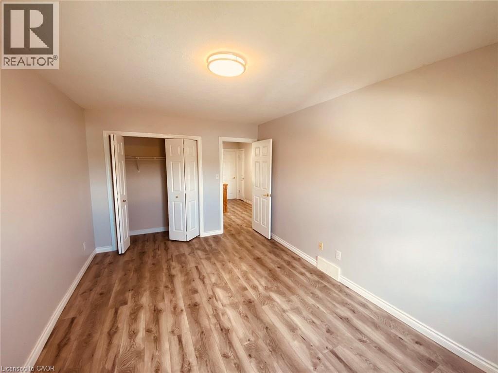 A room with wood flooring and white walls.