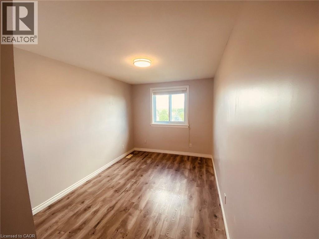 A room with wooden flooring and a window.