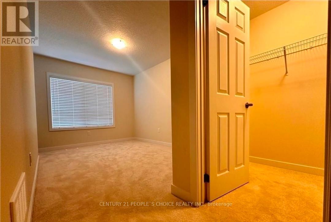 A bedroom with a door and a window.