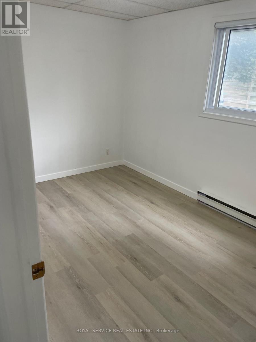 A room with a wooden floor and a window.
