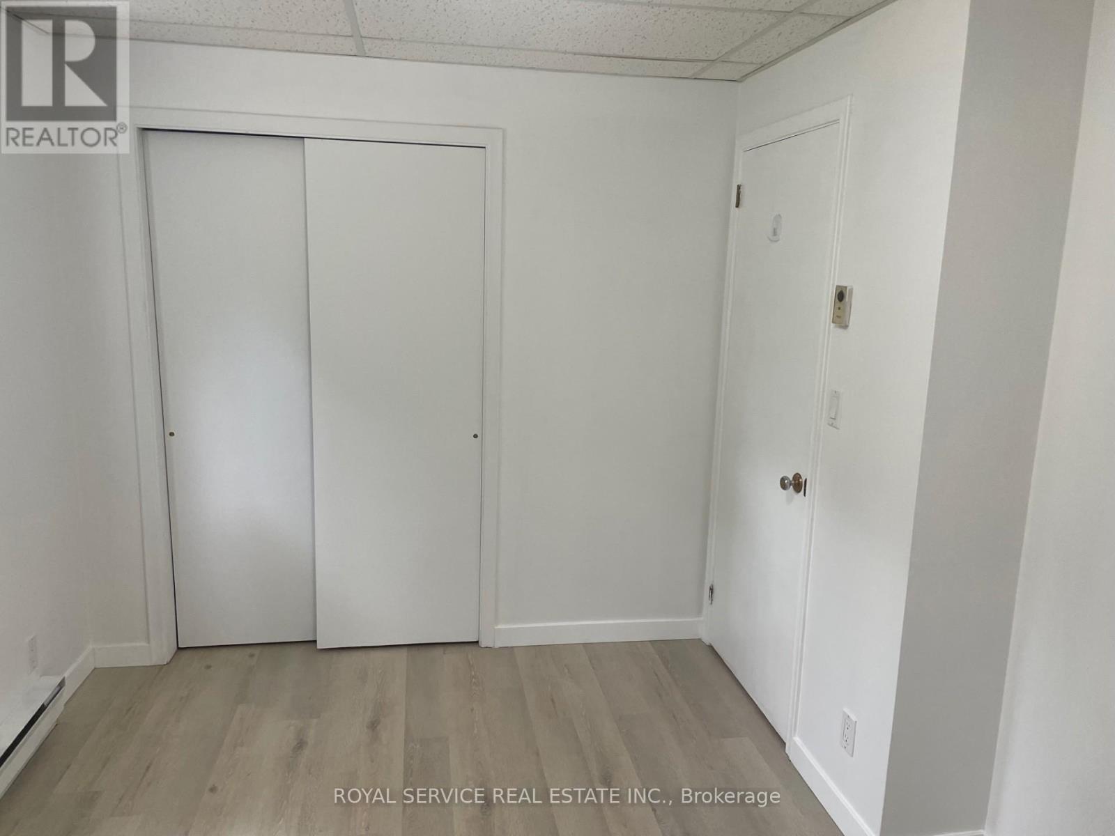 A white door is on the left and a white door with a handle is on the right.