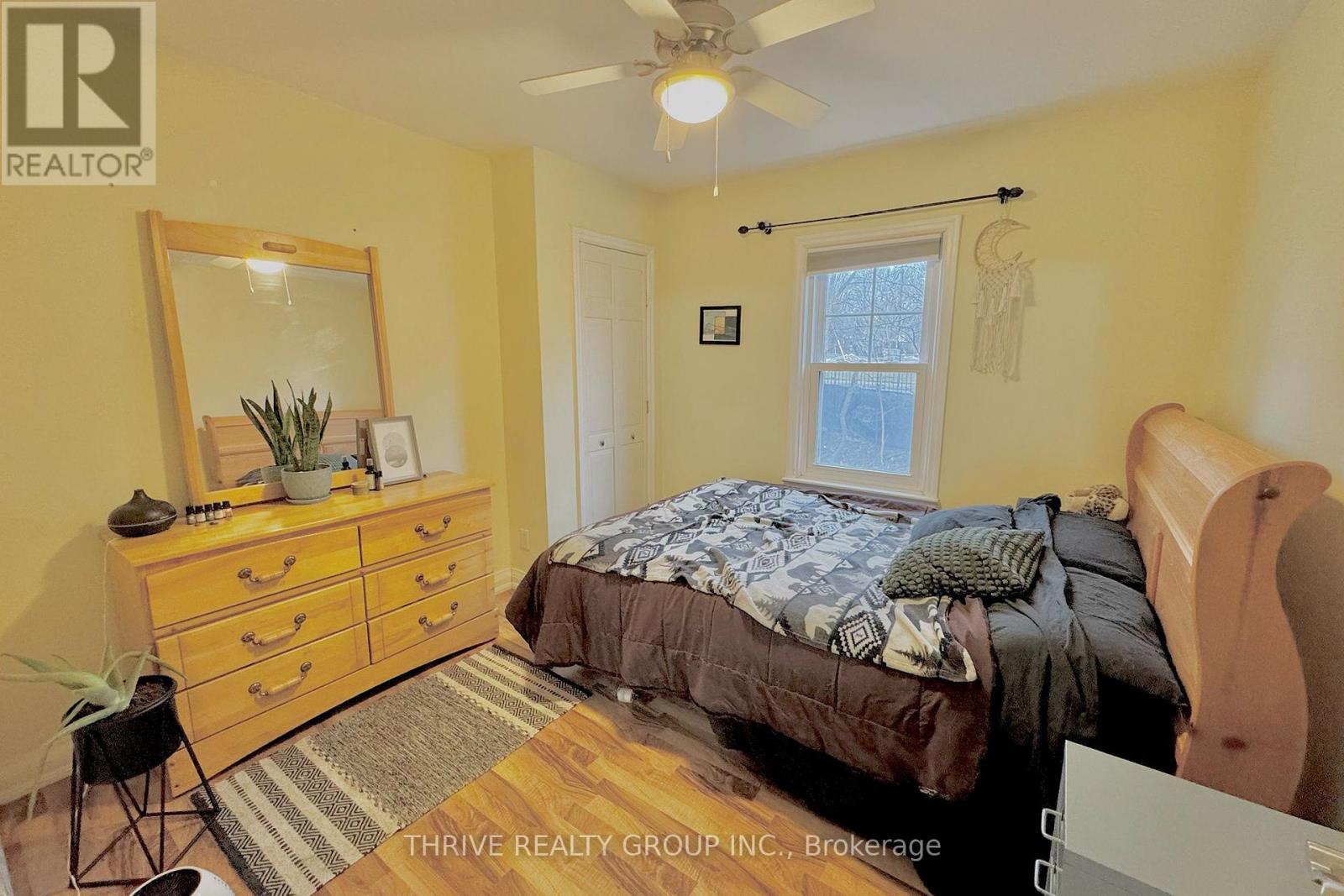 A bedroom with a bed, dresser, and mirror.
