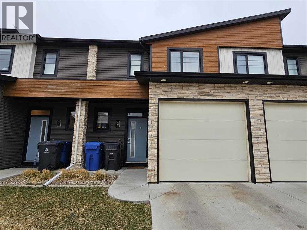 A modern two-story house with a garage door.