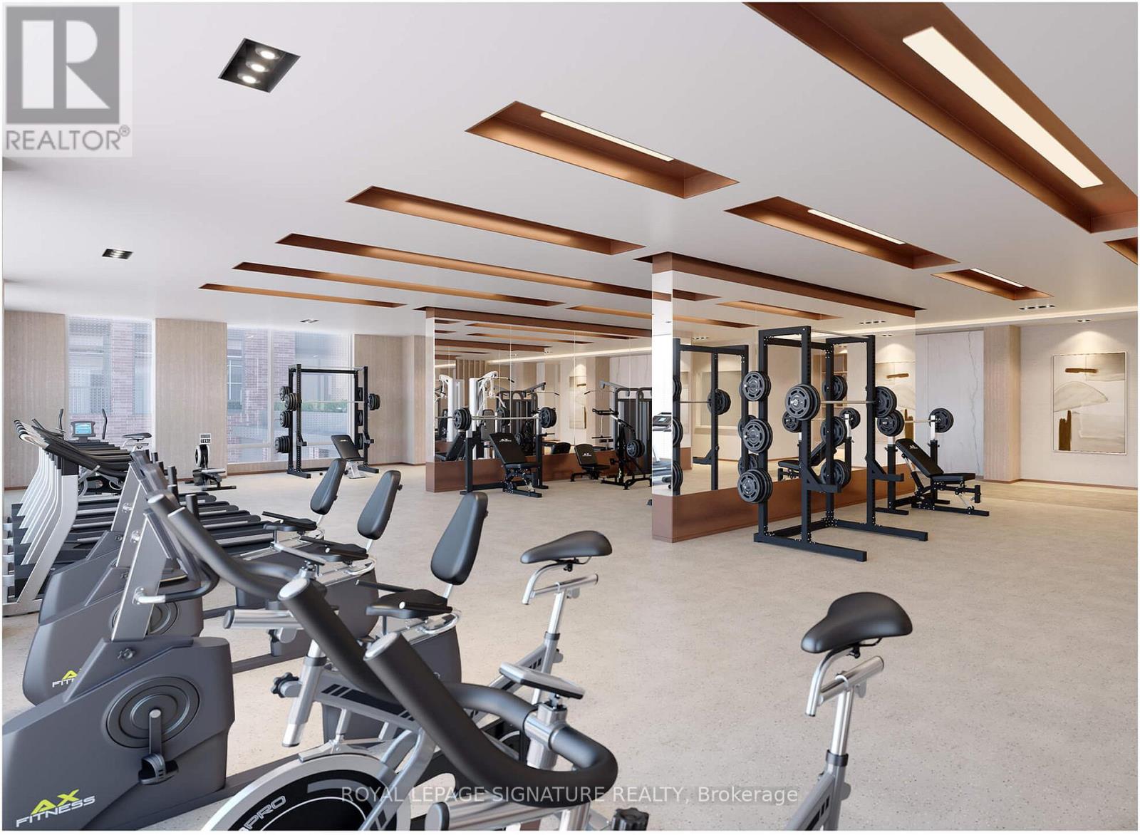 A gym with a row of stationary bikes and a variety of other exercise equipment.