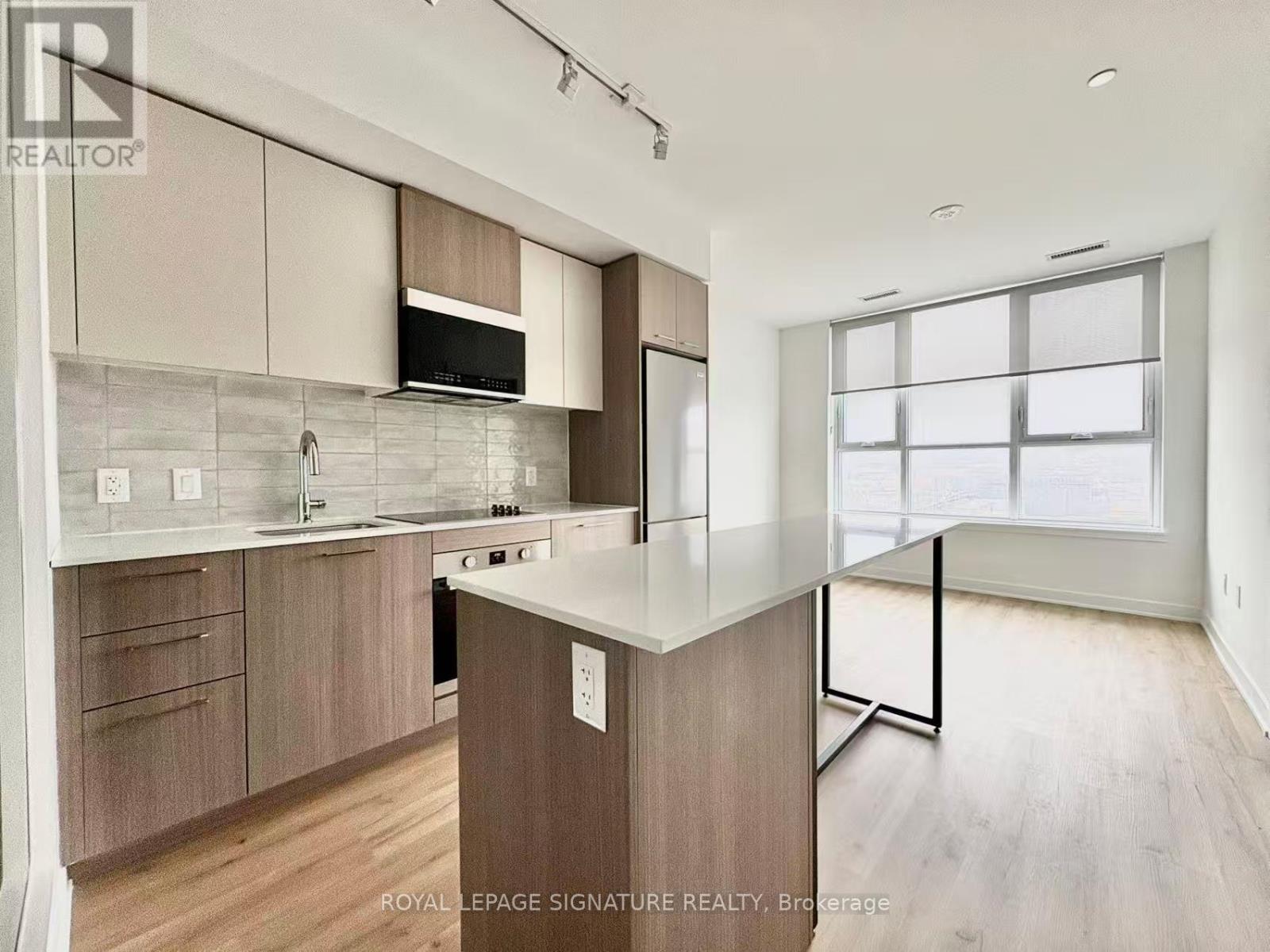 A kitchen with wooden cabinets and a countertop.