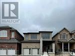 A realtor logo is on a picture of a house.