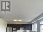 A realtor logo is on the ceiling of a kitchen.