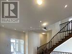 A staircase in a building with a logo that says REALTOR.