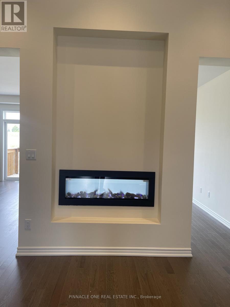 A living room with a fireplace and a tv mounted on the wall.