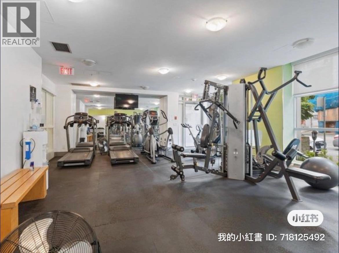 A gym with a variety of equipment including treadmills, weights, and exercise machines.