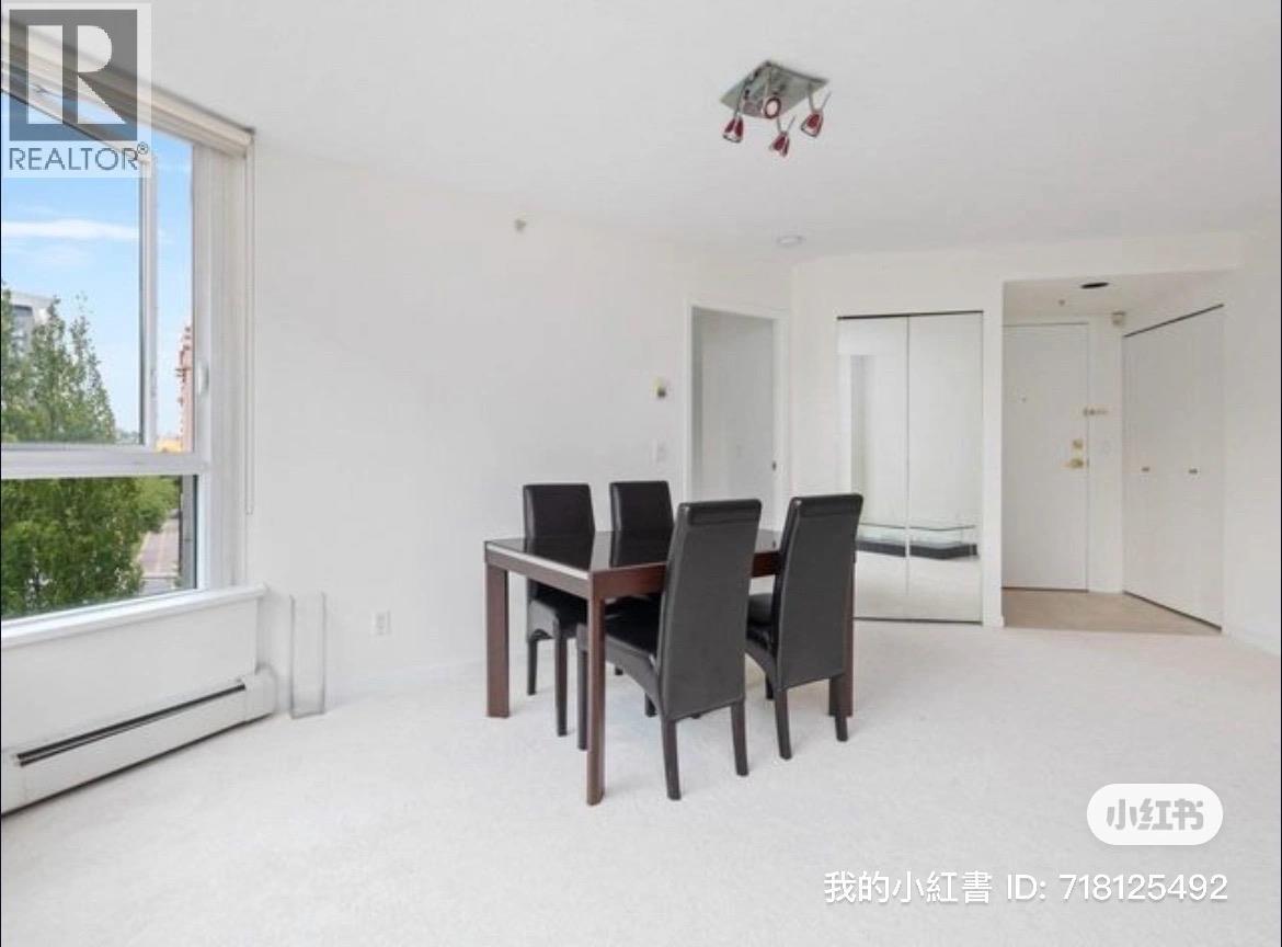 A dining room with a table and chairs.